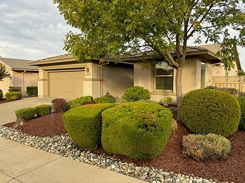 Front yard with professional landscaping and maintenance included.