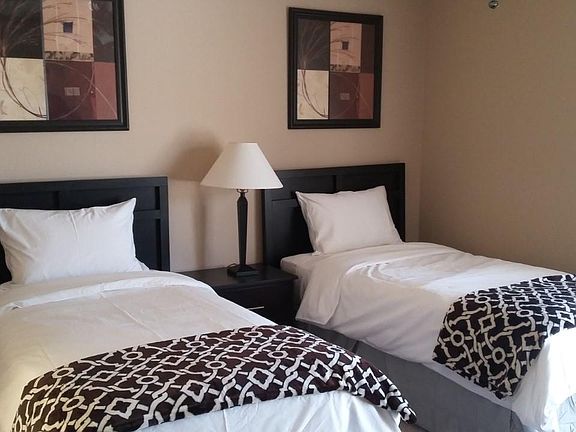 Fully furnished bedroom with bed, mattress, 4 drawer chest, study tables full closet . (Linen not included but can be made available on request with additional fee.)
