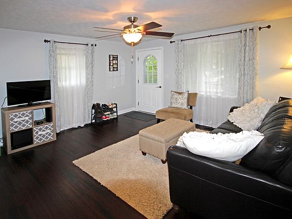 Brand new bamboo floors in the ever so popular espresso color are absolutely gorgeous in the living room, kitchen and hallways offsetting the white trim and doors. There is plenty of room for relaxing in this living room plus it has an updated overhead ceiling fan.