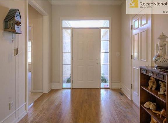 Hardwood floors greet you as you enter the home and the transom and sidelight windows allow the natural light to shine in.