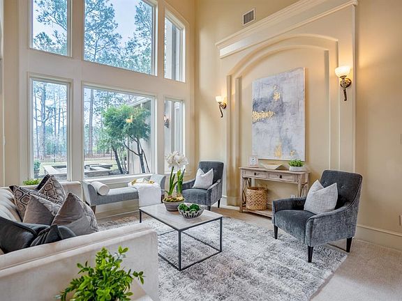 Large windows bring in TONS of brilliant natural light! Don't miss the water fountain feature that is beautifully seen through the windows when seated in the formal living. Make note of the gorgeous architectural feature wall inset which is one of ma