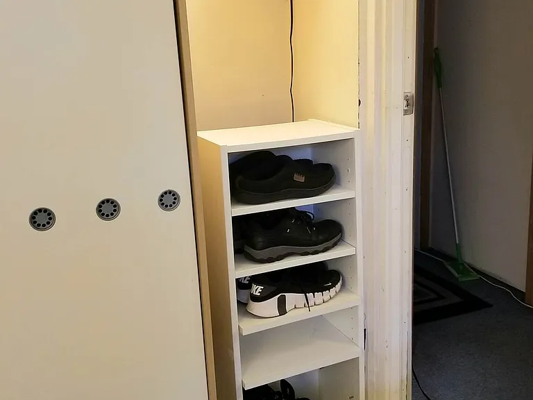 Ivory Room - Armoire, Shoe Rack, Lamp & Shelf, Doorway.