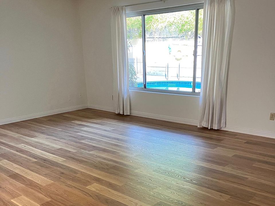 Spacious Living Room and Large Window for Natural Light with View of Swimming Pool