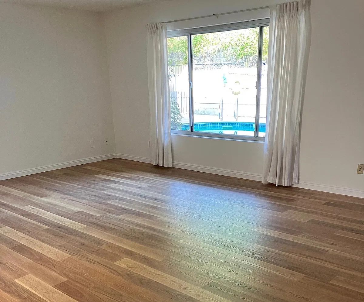Spacious Living Room and Large Window for Natural Light with View of Swimming Pool - 111 Suffolk Ave #C