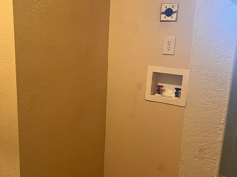 stackable washer/dryer area in primary bathroom