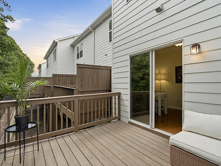 Outdoor patio with a view facing lush greenery (a rare find in the community!)