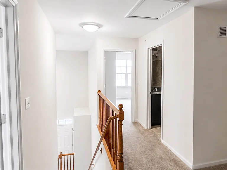 View from the loft toward the shared bathroom and second bedroom.