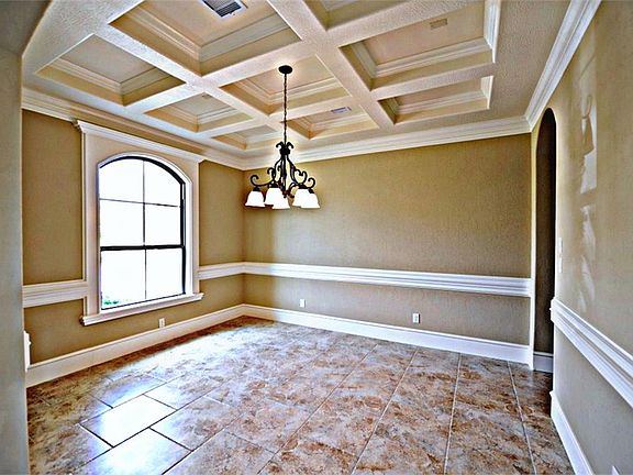 Formal DIning Room WIth Accent Paint & Custom Features Added Such As: Coffered Ceiling Laced WIth Mo