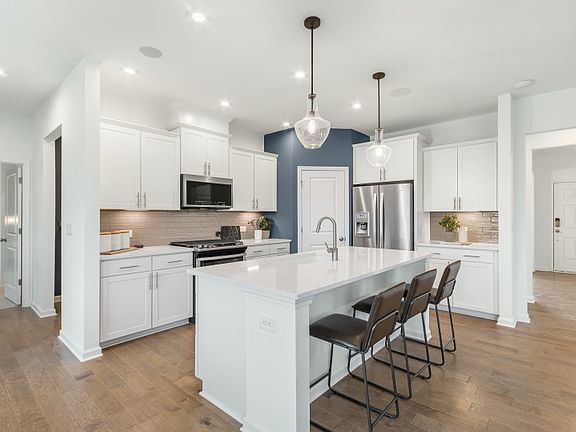 Luxurious Kitchen with Stainless Steel Appliances and Tile Backsplash