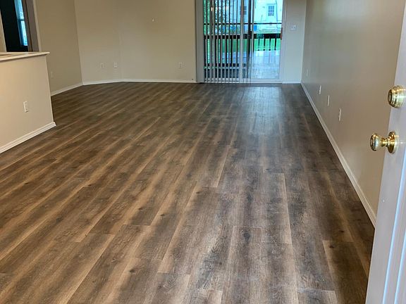 Living room and Dining room from the front door. Also showing is the screened patio