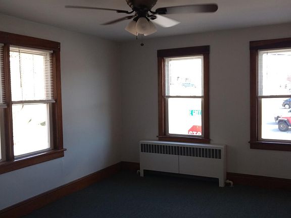 Large bedroom with new ceiling fan and carpet