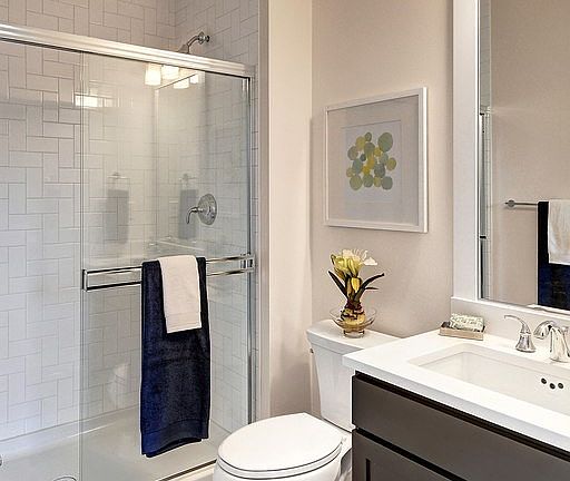 3/4 bath located adjacent to main floor bedroom features quartz counters and tile shower and tile floor.