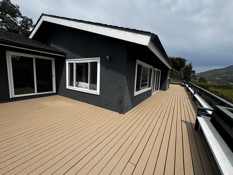 Upper-level wrap-around deck with 3 entrances, primary bedroom, living room & dining room.