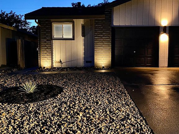 Exterior lighting and eco-friendly landscaping for low water use and maintenance.