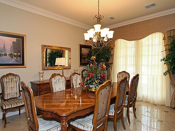 This formal dining space is complete with arched entry and decorative columns accenting the gorgeous