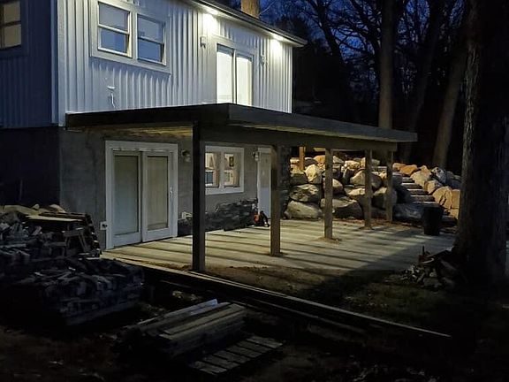 Side view of house at night.
