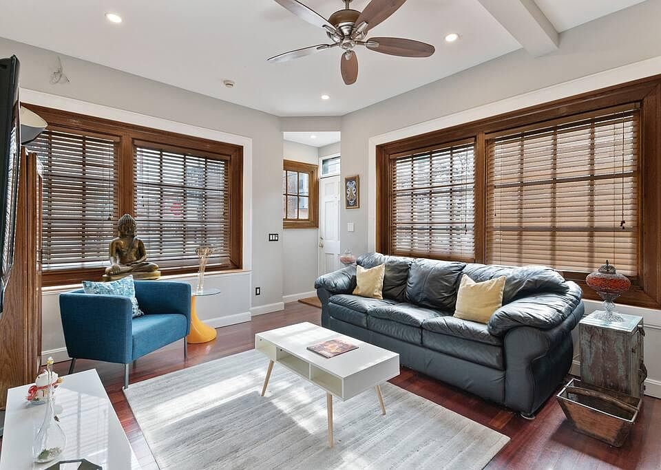 Sun-drenched living room with oak blinds for total privacy
