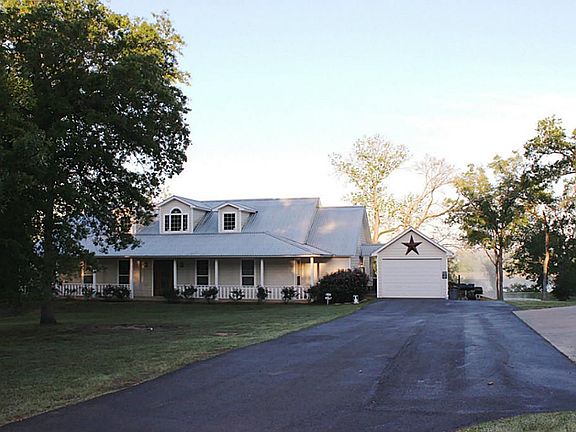 Front view of your new home. Metal roof. Private drive has over 500 ft of pavement from the road to 