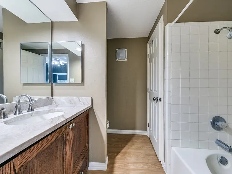 Master bath with stone counters and garden tub.