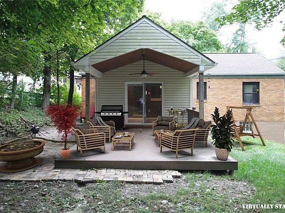 Covered Porch, brick patio are highlights of the largeprivate backyard! Maintenance free decking onporch, ceiling fan provide a 