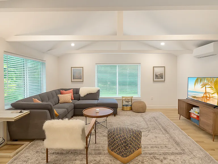 Unwind in the inviting living room, complete with a large sectional, calming neutral tones, and a smart TV_perfect for a cozy movie night or slow morning