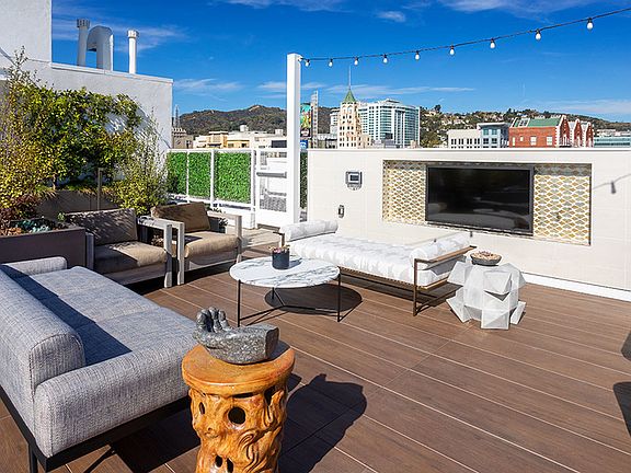 Rooftop sundeck with outdoor TV and lounge areas