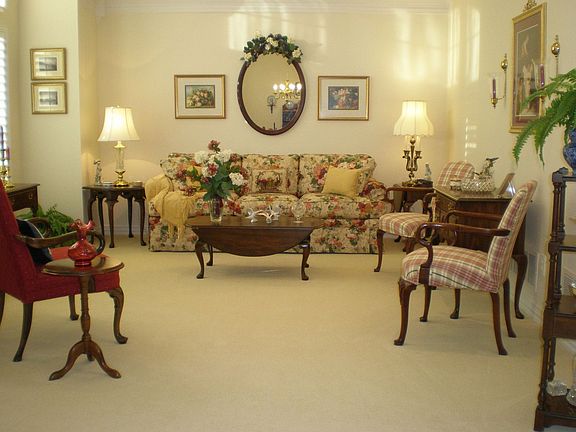 Formal living room with crown molding and chair rail.