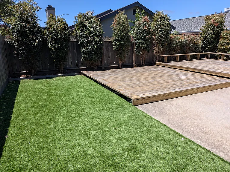 Backyard patio and artificial turf area