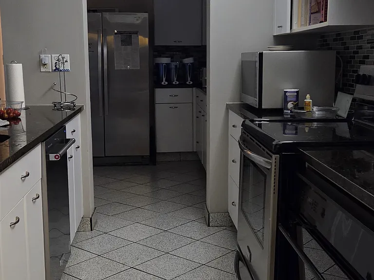 1st floor kitchen. It is a big, double kitchen. There are two sinks and two ovens. One stove. One microwave. One dishwasher.