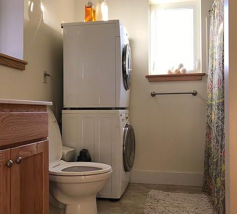 Entrance bathroom has a shower and bathtub. That is where the washer and dryer are located