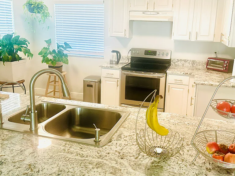 New quartz countertops. New sink. New stove. Updated cabinets with new hardware.