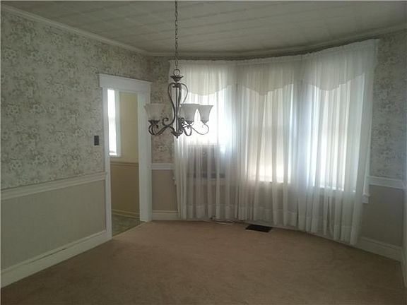 Dining Room with crown moulding and chair rail