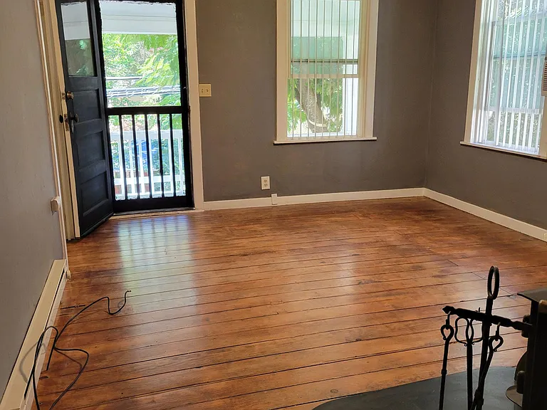 Living Room has original hardwood floors and a wood stove