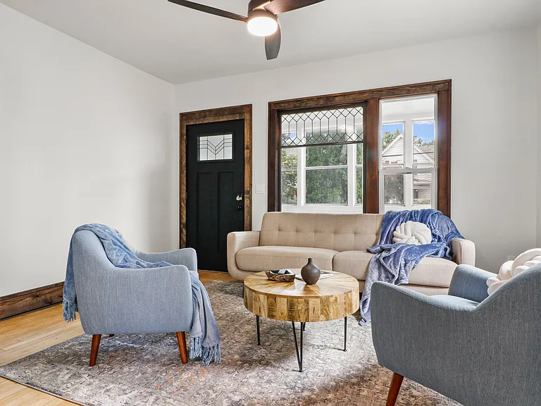 Lovely seating area. Notice the original glass in the big window and the pretty door.