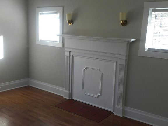 The living room boasts newly refinished hardwoods and the beautiful mantel provides a focal point. Mini blinds throughout the house offer privacy.