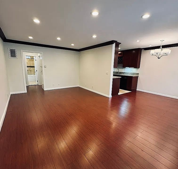 Spacious Living Room with Recessed Lighting and Crown Molding.