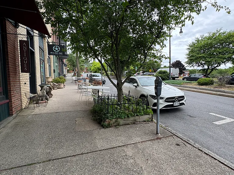 In front of the apartment building.