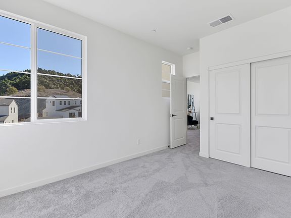 A bright and spacious room with large windows overlooking a scenic outdoor landscape.