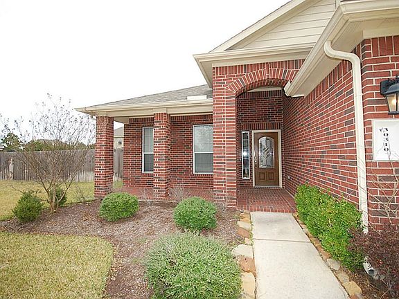 Nice covered porch with a lot of yard next to it to watch the kids or pets play.