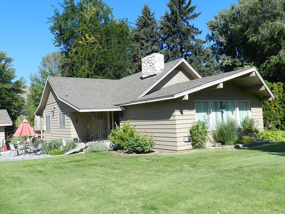 farmhouse from front yard. patio/courtyard private entrance on left