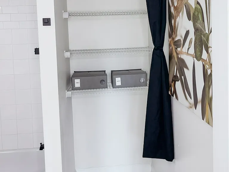 Clean, modern bathroom with ample storage for bathroom essentials and linens