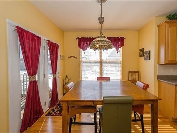 Eating area off kitchen with walkout to cover screened in patio