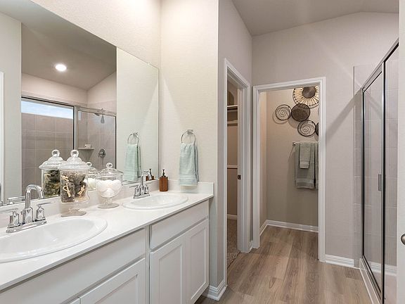 Enjoy dual sinks and an oversized walk-in shower in your new primary bathroom.