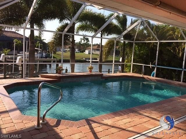 Pavered Lanai surrounds Heated Pool with Waterfall Feature