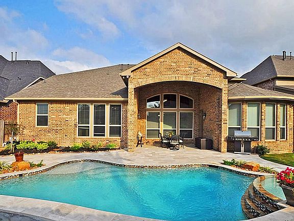  View of back of the home. Plenty of patio space and some extra grass area leftover