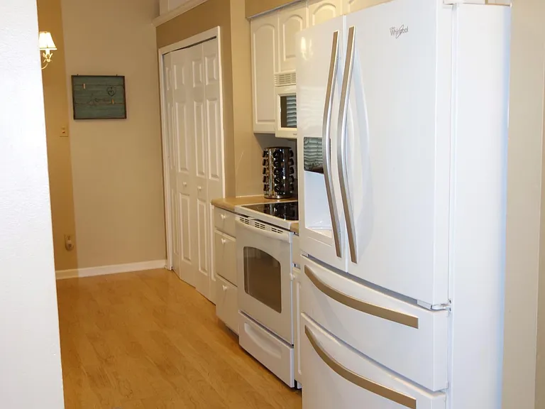 Kitchen has large pantry to the left of the stove.