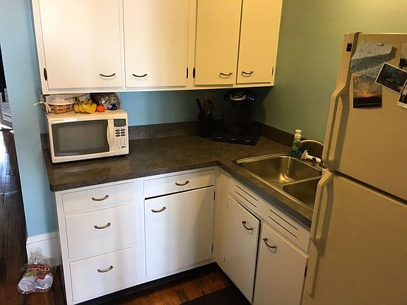 Recently refinished kitchen with electric stove.
