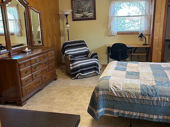 Queen bed, night stands, double closet poles, computer desk, recliner chair, dresser with mirror.