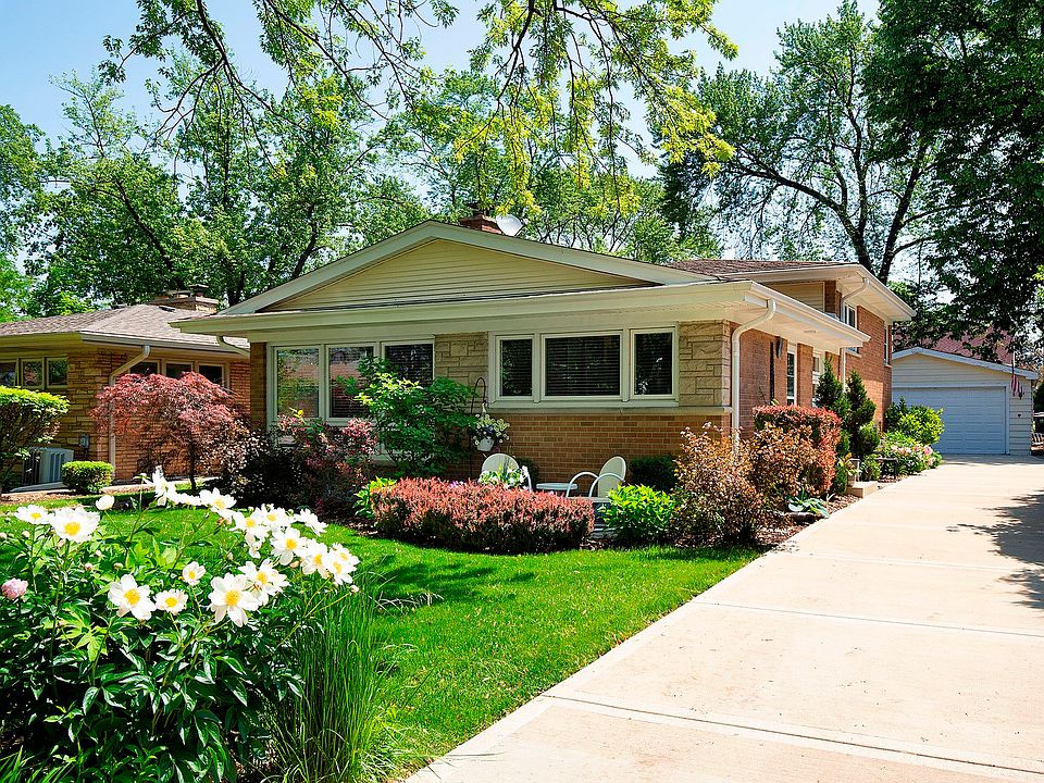Solid brick split with tremendous curb appeal. Lush landscaping and new driveway