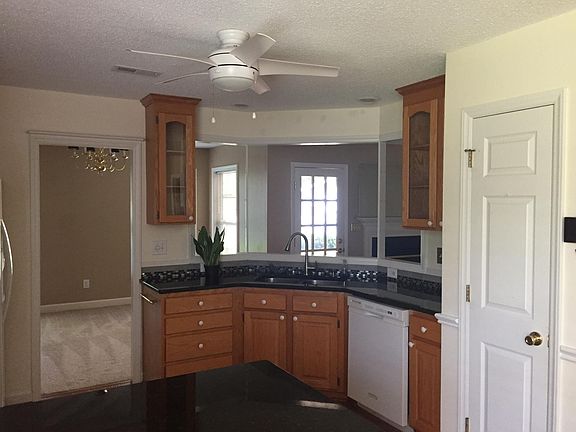 Kitchen with granite counter tops/new ceiling fan/dining room entry on the left